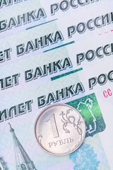 Fototapeta premium A lot of Russian banknotes with a face value of one thousand rubles and one metal coin ruble