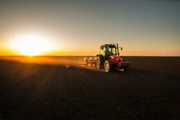 Farmer with tractor seeding