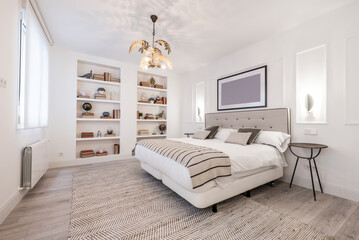 bedroom with double beds pushed together, beige fabric headboard combined with cushions and...