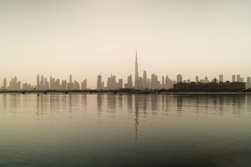 Fototapeta na wymiar Skyline of Dubai reflecting in the water