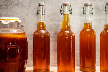 Fresh kombucha beverage in glass swing-top bottles. Healthy and refreshing fermented drink.