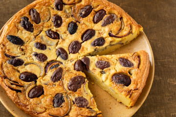 Farinata (Italian chickpea pancake) with kalamata olives and red onion. Cut slice.