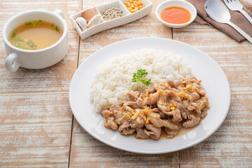 Stir-Fried Pork with Garlic and and pepper with cooked thai jasmine rice in white plate,popular Thai Street food
