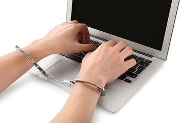 Woman in handcuffs typing on laptop against white background, closeup. Internet addiction