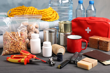 Disaster supply kit for earthquake on black wooden table