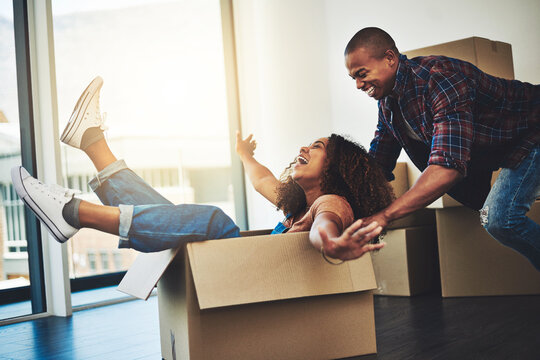 Going For A Magic Box Ride In Our New Home. Shot Of An Attractive Young Couple Moving House.