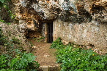 Fototapeta na wymiar Entry to the cave Cueva de les Gotetes at the footpath to Castell de Xativa,Xativa,Province Valencia,Spain,Europe 