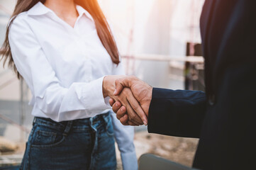 Businessman and businesswoman shaking hands, business deals and congratulations on success concept.