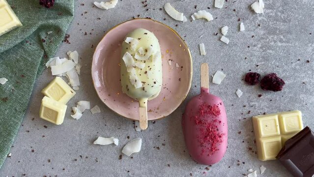 White and pink cakesicles with ruby and white chocolate. Homemade baked popsicles. Chocolate pie pops