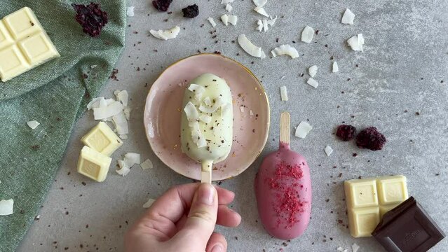 White and pink cakesicles with ruby and white chocolate. Homemade baked popsicles. Chocolate pie pops