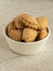 White ceramic bowl with cottage layer cookies with sugar and cinnamon