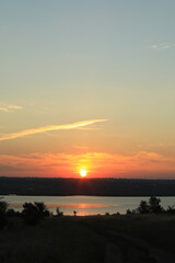 Picturesque view of beautiful cloudy sky over river at sunrise