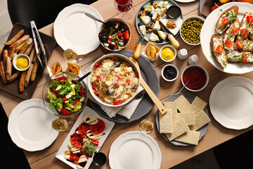 Brunch table setting with different delicious food indoors, top view