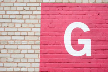 Letter G on brick wall