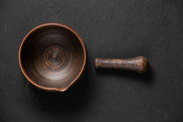 Clay pots for cooking. Pots of clay of a light colour. Baking dishes on a dark background. A clay pot with a lid for roasting. Vintage kitchen utensils for cooking.