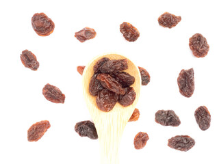Raisin in spoon and bunch isolated on white background. Macro. Vegetarian concept