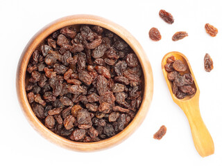 Raisin in wooden bowl and scoop, bunch isolated on white. Macro. Healthy food concept