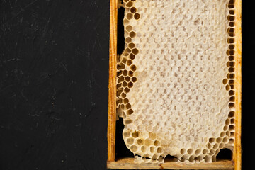 Pieces honeycomb with honey on a dark wooden background.Top view. Copy space.