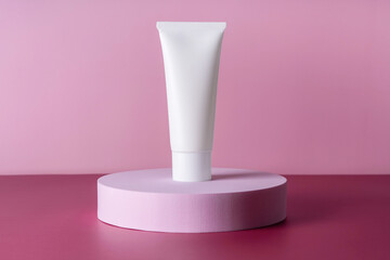 Cream bottle, lotion, mousse showcase for skincare routine. Beauty cleanser, shampoo stand. Sunscreen presentation mock up. White tube of cosmetic product on podium pedestal on pink background.