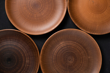 Ancient clay plate on a black background