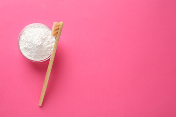 Bowl of tooth powder and brush on pink background, flat lay. Space for text