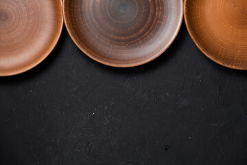Ancient clay plate on a black background