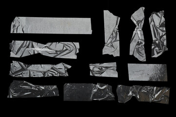 Many pieces of transparent adhesive tape on black background, flat lay