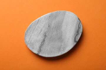 Stylish cup coaster on orange background, top view