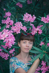 Young woman in blooming park sunny day outdoors.