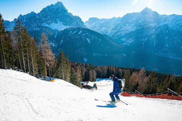 High angle view of skier skiing on slope against mountain range