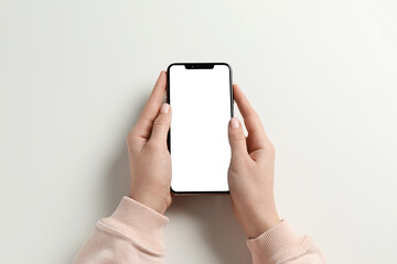 Woman with smartphone on white background, top view