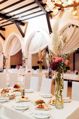 bright banquet hall tables set white tablecloth