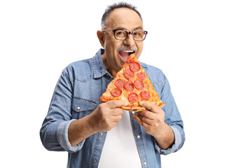 Happy mature man biting a slice of pepperoni pizza