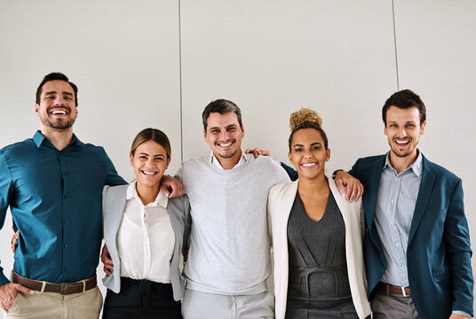 Were team players with the golden mission of reaching success. Portrait of a group of businesspeople standing in an office.