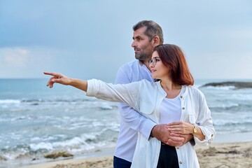 Outdoor portrait of mature couple hugging on the seashore