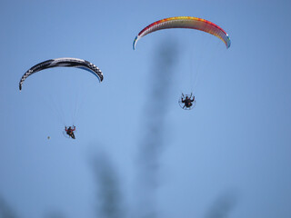 Paraglider flying with the blue sky in the background