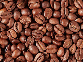 Antique vintage retro bronze coffee mill on black wooden board with roasted coffee beans