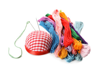 Colorful embroidery floss set and needle cushion on white background
