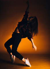 Contemporary style dancer on orange wall