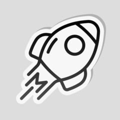 Simple rocket icon, space ship. Linear sticker, white border and simple shadow on gray background