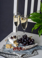 Food photography of white wine, cheese, grapes