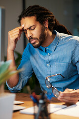 Obraz premium I cant stand this stress any longer. Cropped shot of a young designer looking stressed out while working late in an office.