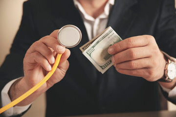 Piggy bank with stethoscope, tax offset concept