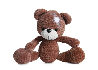 Cute toy bear with sticking plaster isolated on white. Children's hospital