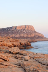 Fototapeta na wymiar Rock formations near the beach with soft sunset light