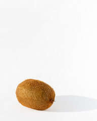 Ripe unpeeled kiwi fruit on a white background, copy space. Kiwi is a natural dietary product, a source of vitamins and antioxidants