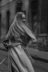 Black and white young beautiful girl portrait. Attractive happy woman with long blond wavy hair. Blur background.