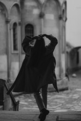 Obraz premium Black and white photo young beautiful woman silhouette. Attractive happy girl with long blond wavy hair. Back view. Blur background.