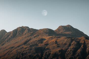 Dramatic mountain landscape view with a moon in Blea Tar, Lake District, United kingdom