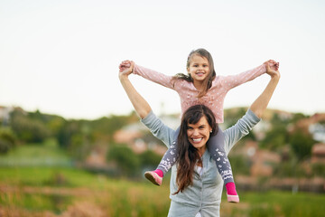 Feeling on top of the world. Portrait of a mother and daughter enjoying some quality time together outdoors.